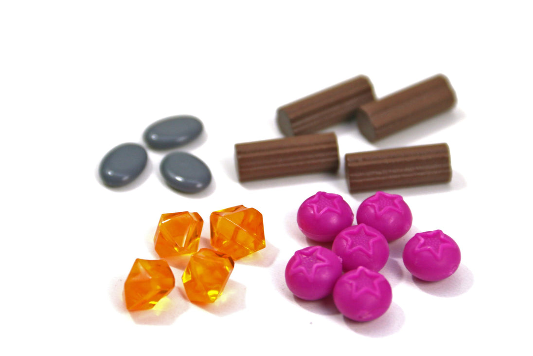 Close-up of resource stones, gems, and wood pieces in Everdell