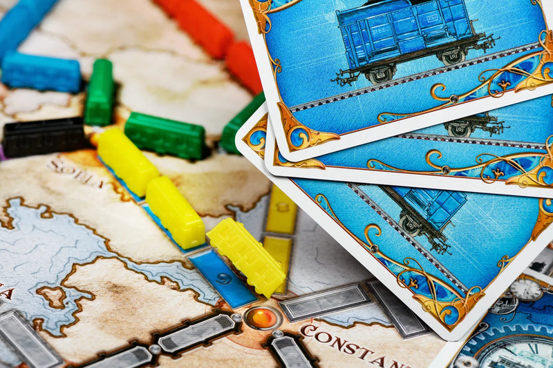Close-up van speelkaarten en treinstukken